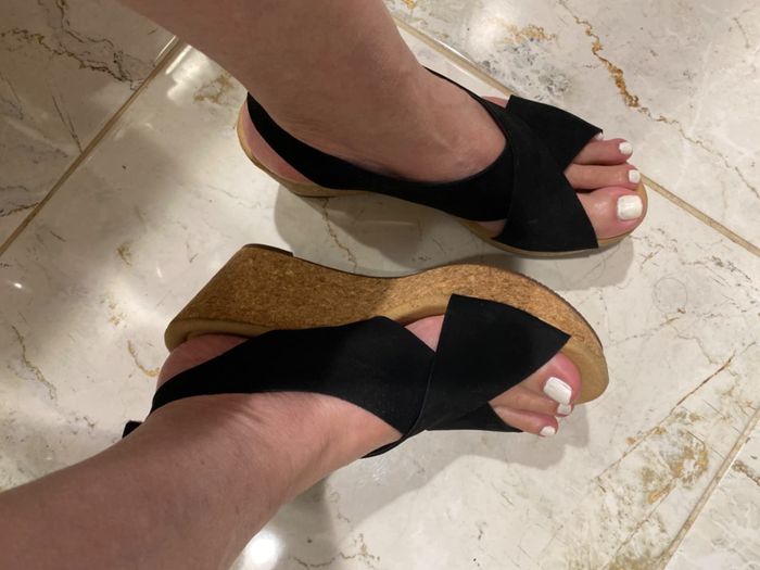 a person wearing platform sandals, with a close-up of their feet