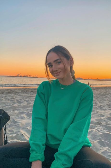 A reviewer styling the kelly green sweatshirt