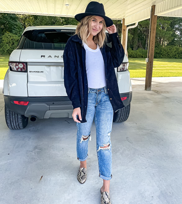 Reviewer layering the top over a T-shirt and pairing it with jeans