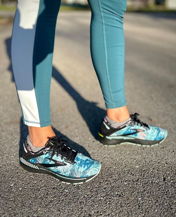 Reviewer wearing blue running shoes