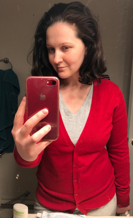 A reviewer modeling the cardigan in a vibrant red shade