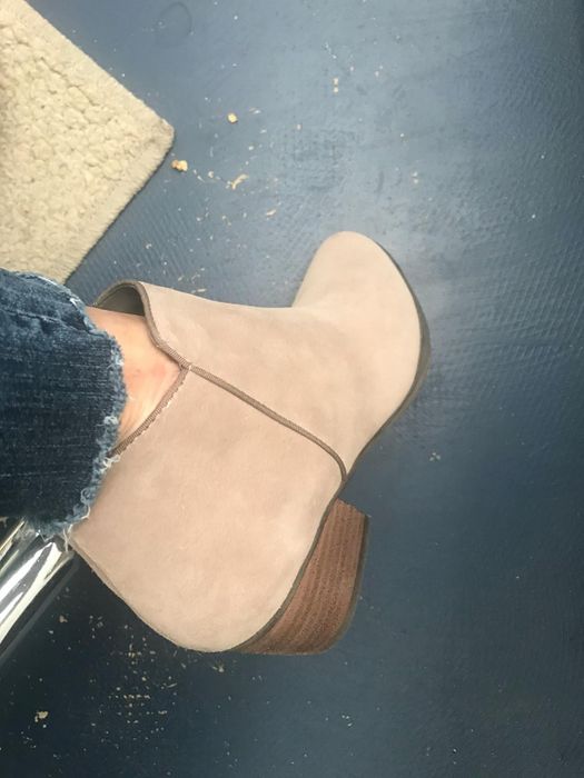 Reviewer wearing the same boots in a sand suede color.