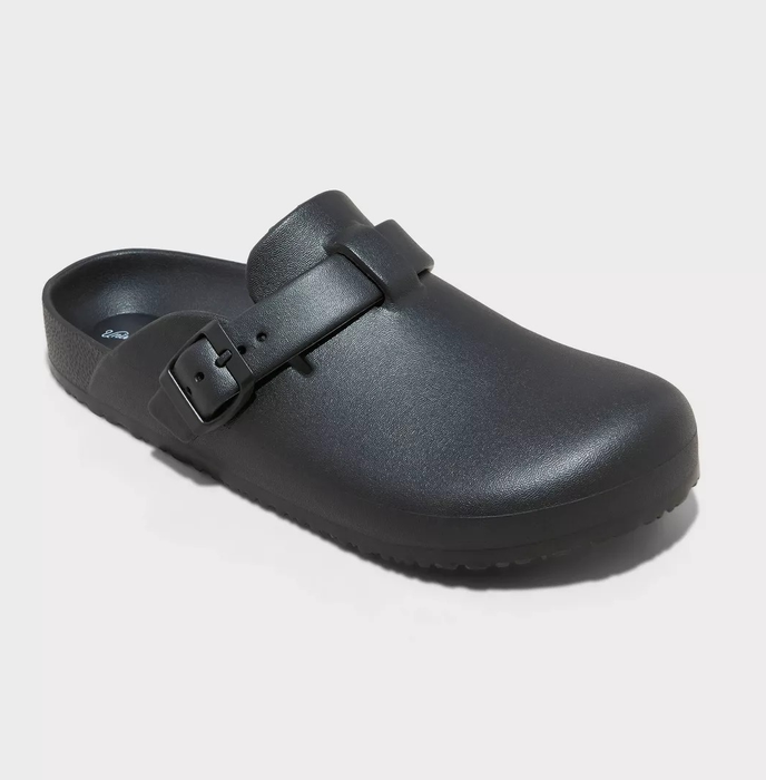 A single black clog-style shoe with a strap and buckle at the front
