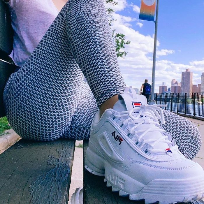 Close-up of the reviewer sporting the white platform sneakers