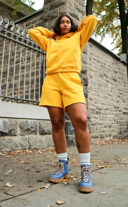 A model showcasing the indigo-colored Thesus weekend boots