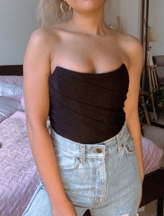 reviewer showcasing the black bustier, proving how versatile and flattering it is for any occasion