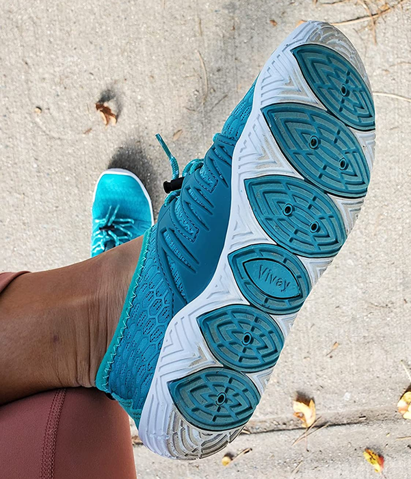 Close-up shot of the reviewer showcasing the shoe's underside