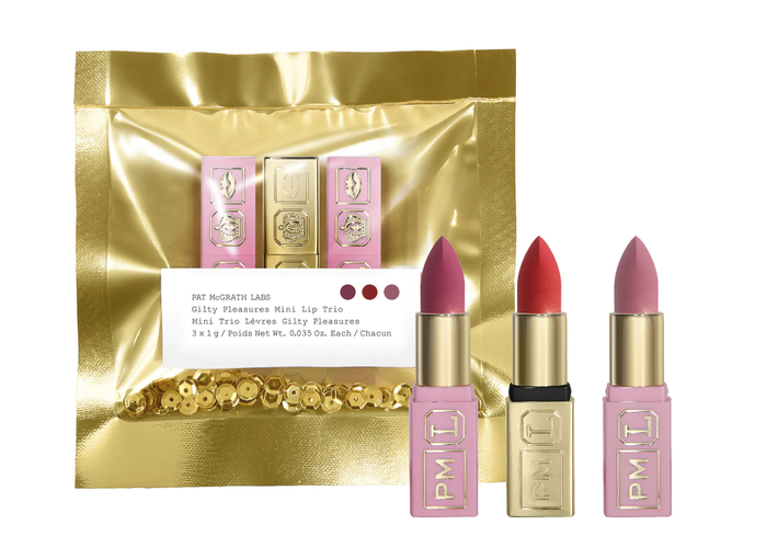 A set of three lipsticks in pink, mauve, and red, elegantly packaged in gold.