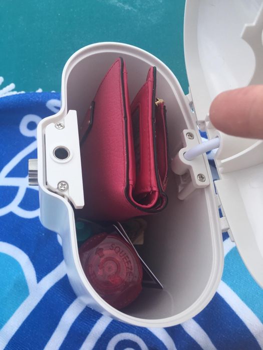 A reviewer demonstrates the inside of the lock box, showing how easily a wallet fits inside
