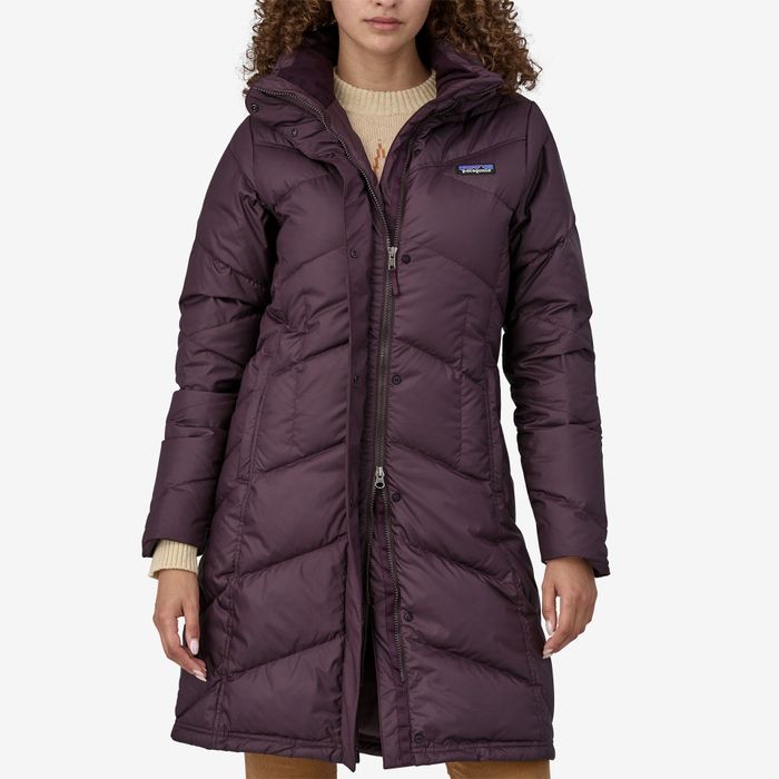 A woman wearing a plum-colored coat