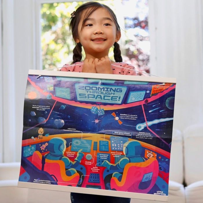 a child proudly displaying a space-themed poster