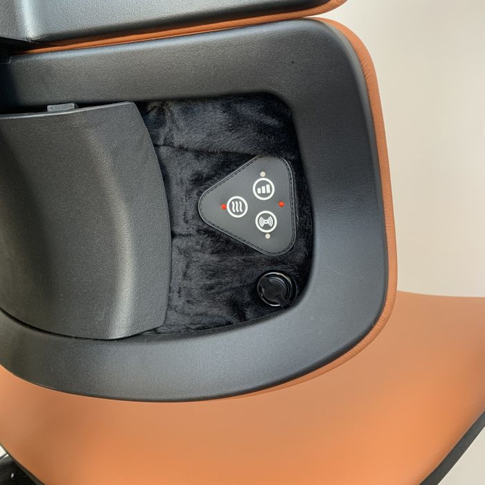 A close-up of the heat and massage control buttons on the chair.
