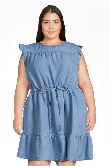 Model wearing the medium wash denim dress