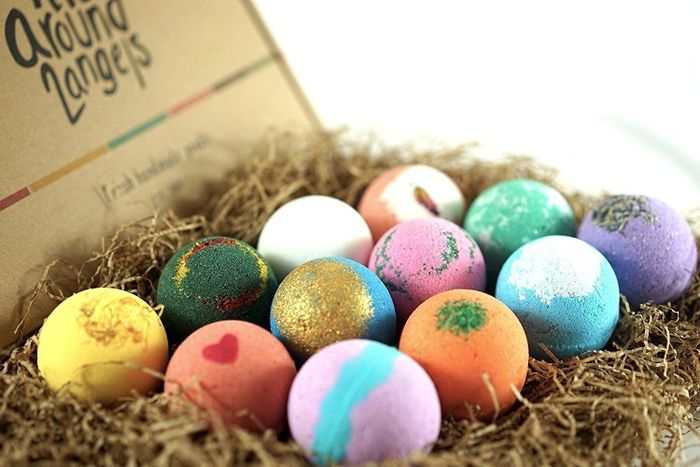 A vibrant box filled with colorful bath bombs ready for a relaxing soak.