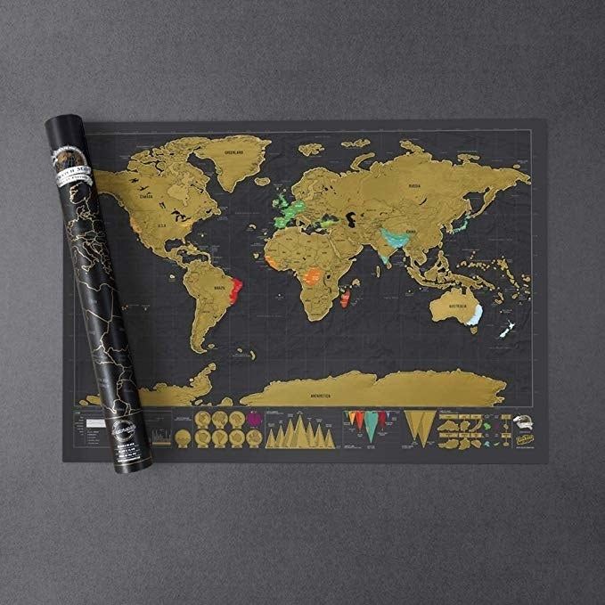 The black map background with gold scratch-off coating, revealing a vibrant underlayer of countries.