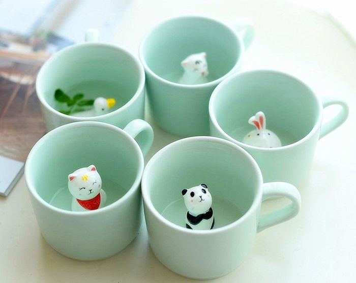 Five of the small mint mugs, each with a different animal figure at the bottom, including a duck, cat, panda, bunny, and tiger.