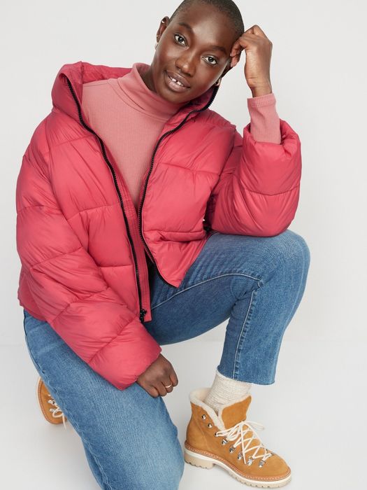 Model wearing a pink puffer jacket.