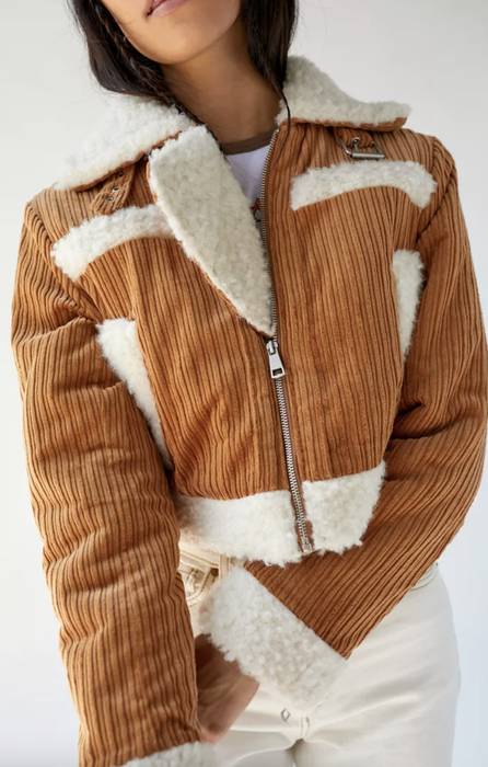 Model showcasing a cozy fleece-lined brown corduroy jacket
