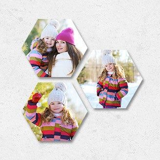 Three hexagonal prints of a mom and her child enjoying the snow together.