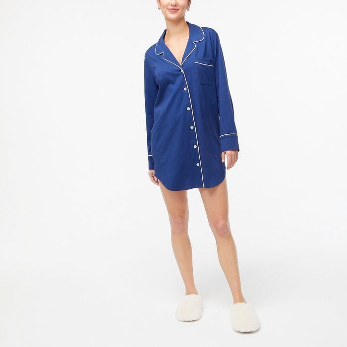 A model showcasing a blue button-down nightgown with detailed button accents