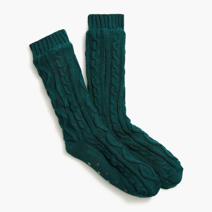 A pair of green cable-knit slipper socks