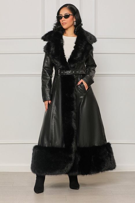 A model showcasing a longline faux leather coat with faux fur detailing