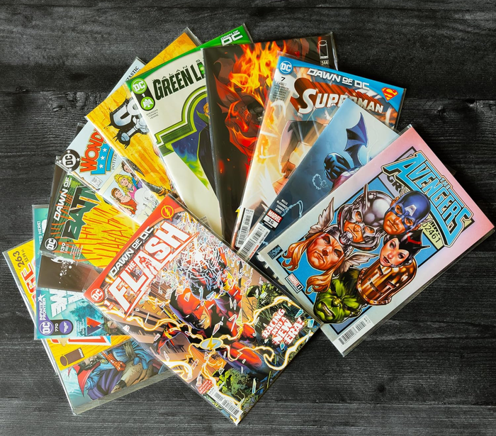 a variety of comics spread out on a table