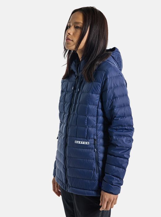 Model sporting a dark blue, lightly padded jacket.