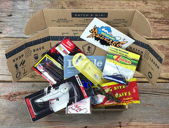 the opened Mystery Tackle Box reveals an assortment of baits, lures, and tackles