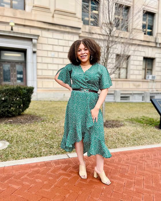 A photo from a reviewer featuring them wearing the green maxi dress adorned with white dots.