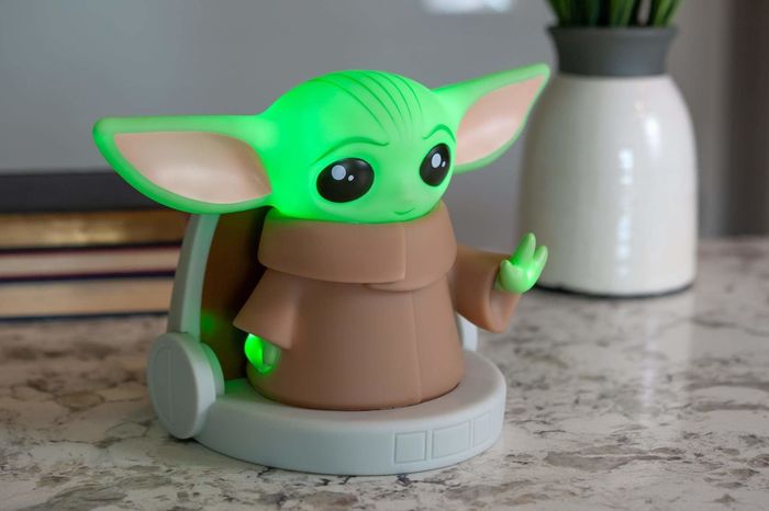 The seven-inch lamp shaped like an adorable Baby Yoda sitting in his pod.