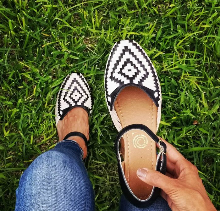 Ankle-strap woven shoes featuring a black and white diamond pattern on top.