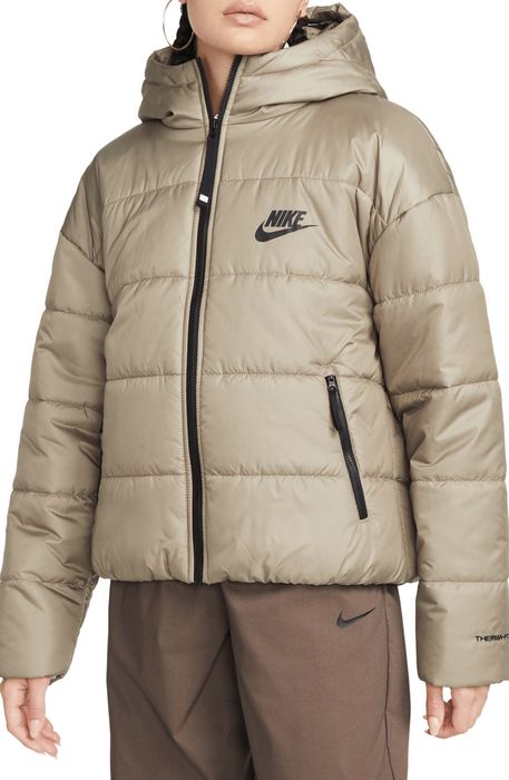Model showcasing a tan Nike puffer jacket