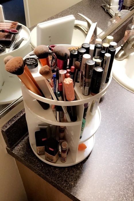 A reviewer’s white organizer packed with beauty products, showcasing its capacity for keeping everything tidy.