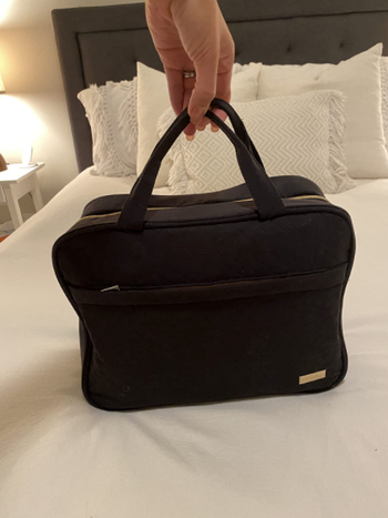 Image of the bag closed and propped up on the bed