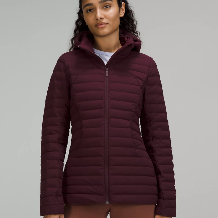 Model wearing the Pack It Down jacket in a rich dark red