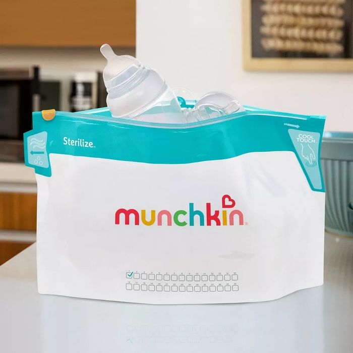 White plastic bag with a teal top, featuring a brand logo on the front, containing baby bottles inside.