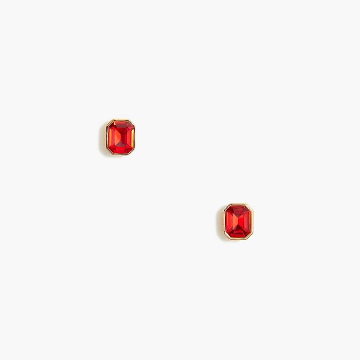 A pair of red and gold-toned earrings