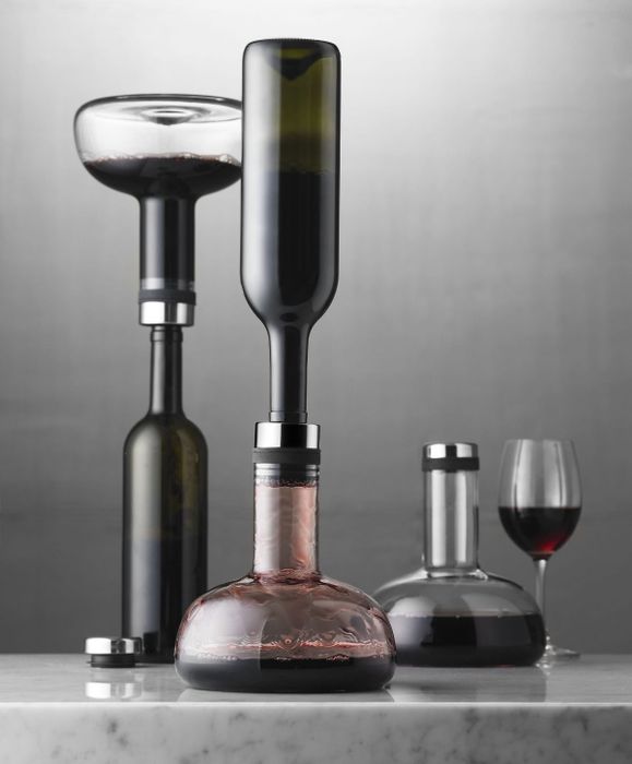 A decanter with a bottle dripping from above.