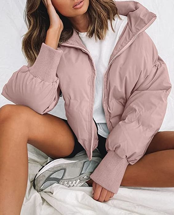 Model wearing a pink zippered puffer jacket