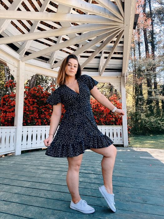 A reviewer is wearing the exact same dress, but in a classic black color.