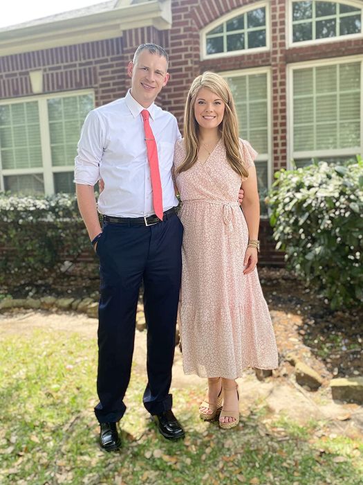 The reviewer is wearing a delicate light pink wrap dress.