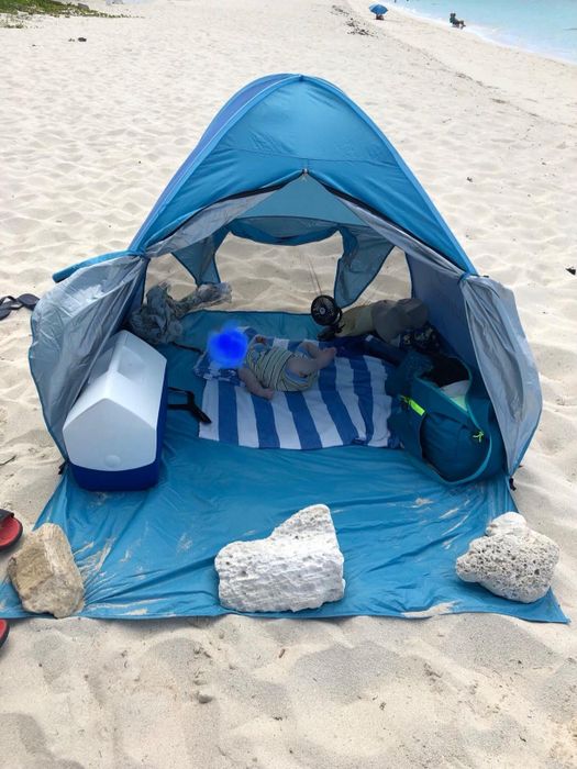 Image of the blue beach tent set up on the sand