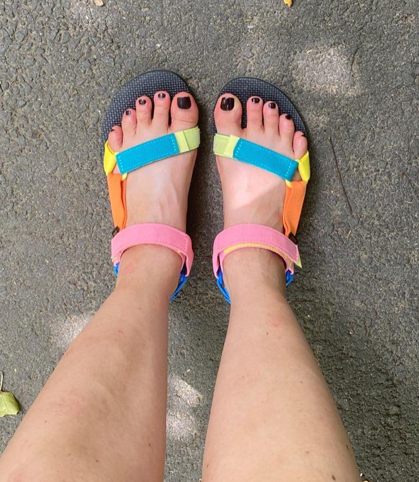 Reviewer's feet in vibrant multicolored sandals.
