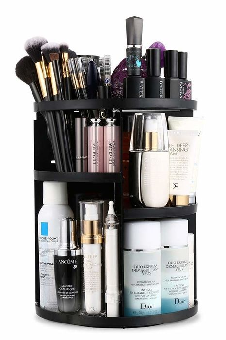 The circular multi-tiered organizer holding a variety of makeup products and brushes neatly in place.