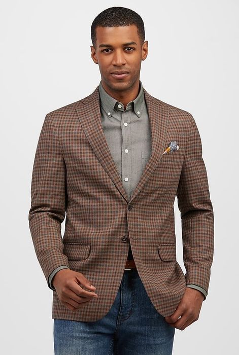 A model showcasing a vibrant, multi-colored sportcoat paired with jeans.