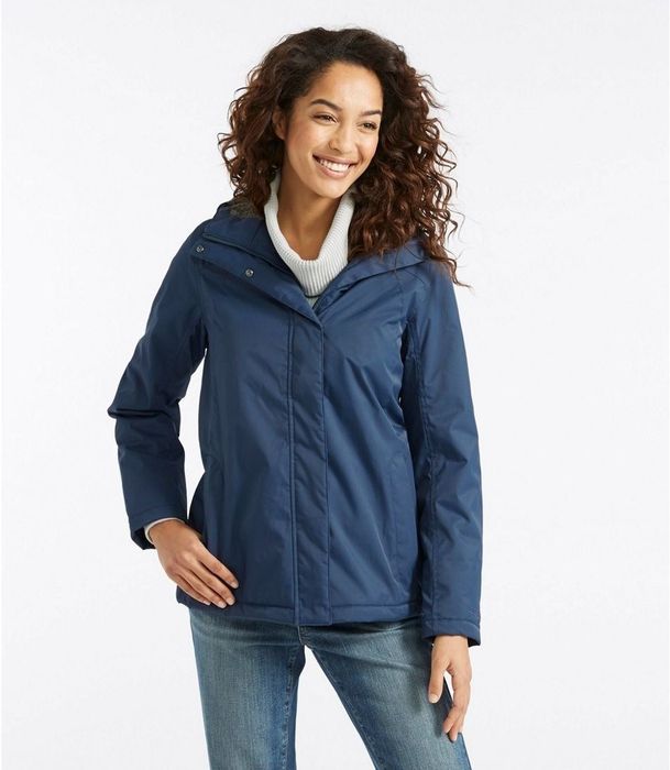 Model styled in a dark blue winter coat