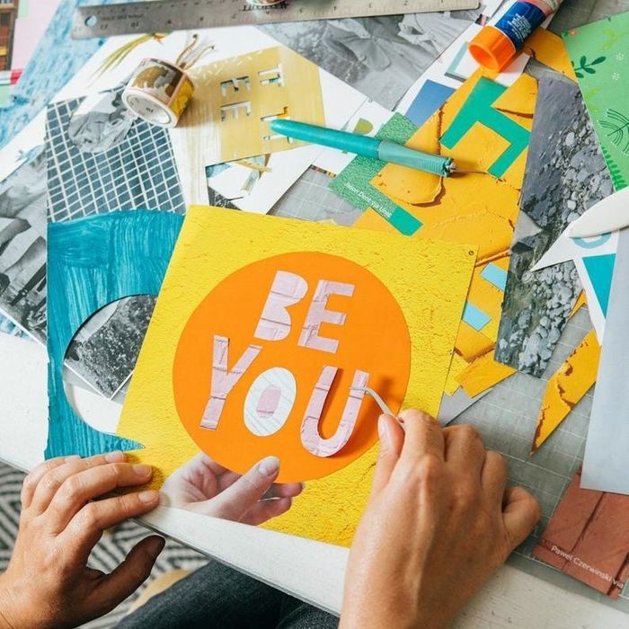 Hands cutting and arranging the magazine’s pages to form a stunning collage.