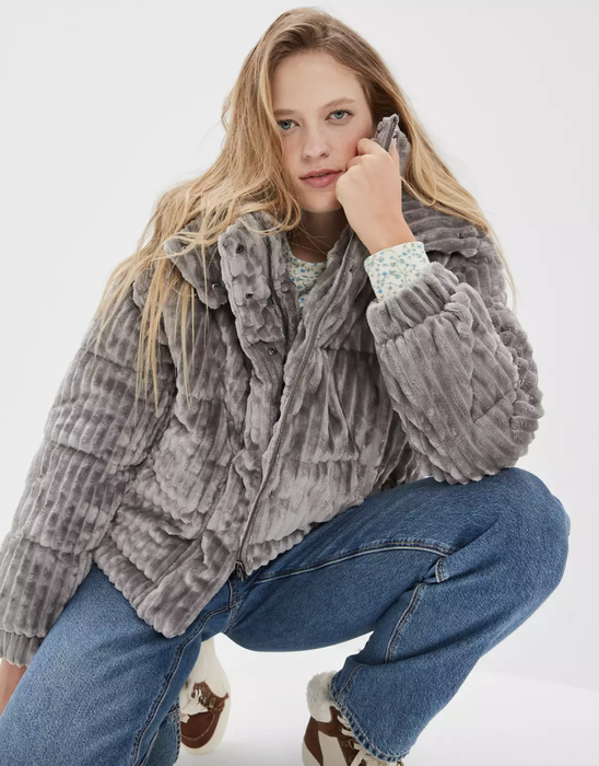 Model sporting a grey textured puffer jacket