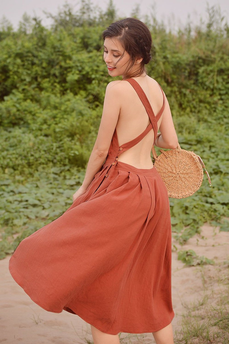 A model showing off the open back with crisscross straps.